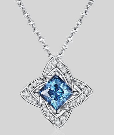 Fashion jewelry pendant necklace with a blue square-cut gemstone and diamond-studded petal motif