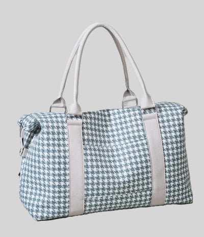 Luggage and overnight bag with blue and white houndstooth pattern and beige straps.