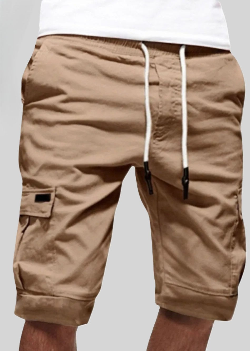 Men's khaki cargo shorts with white drawstrings and side pockets.