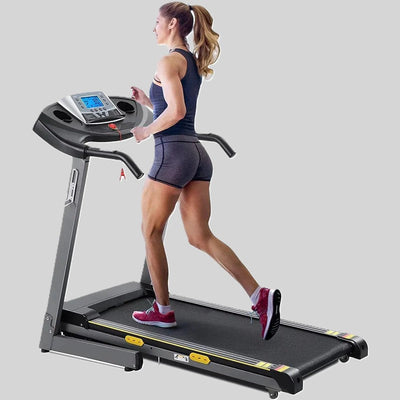Woman jogging on a treadmill with a digital display and safety key.