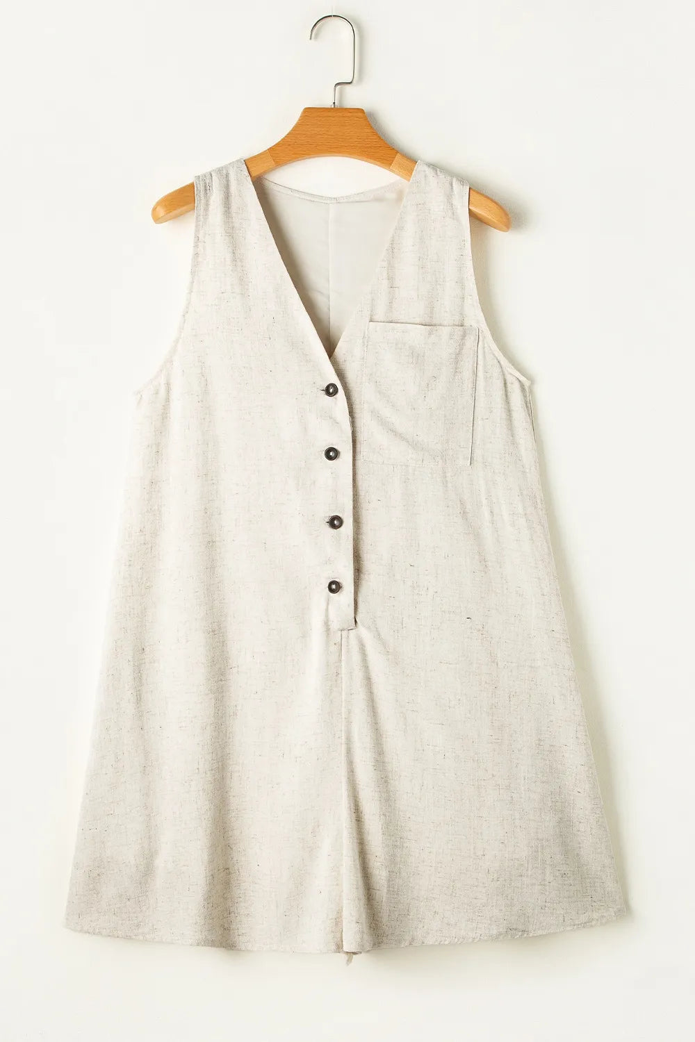 Light beige sleeveless romper, V-neck with button-front and patch pocket