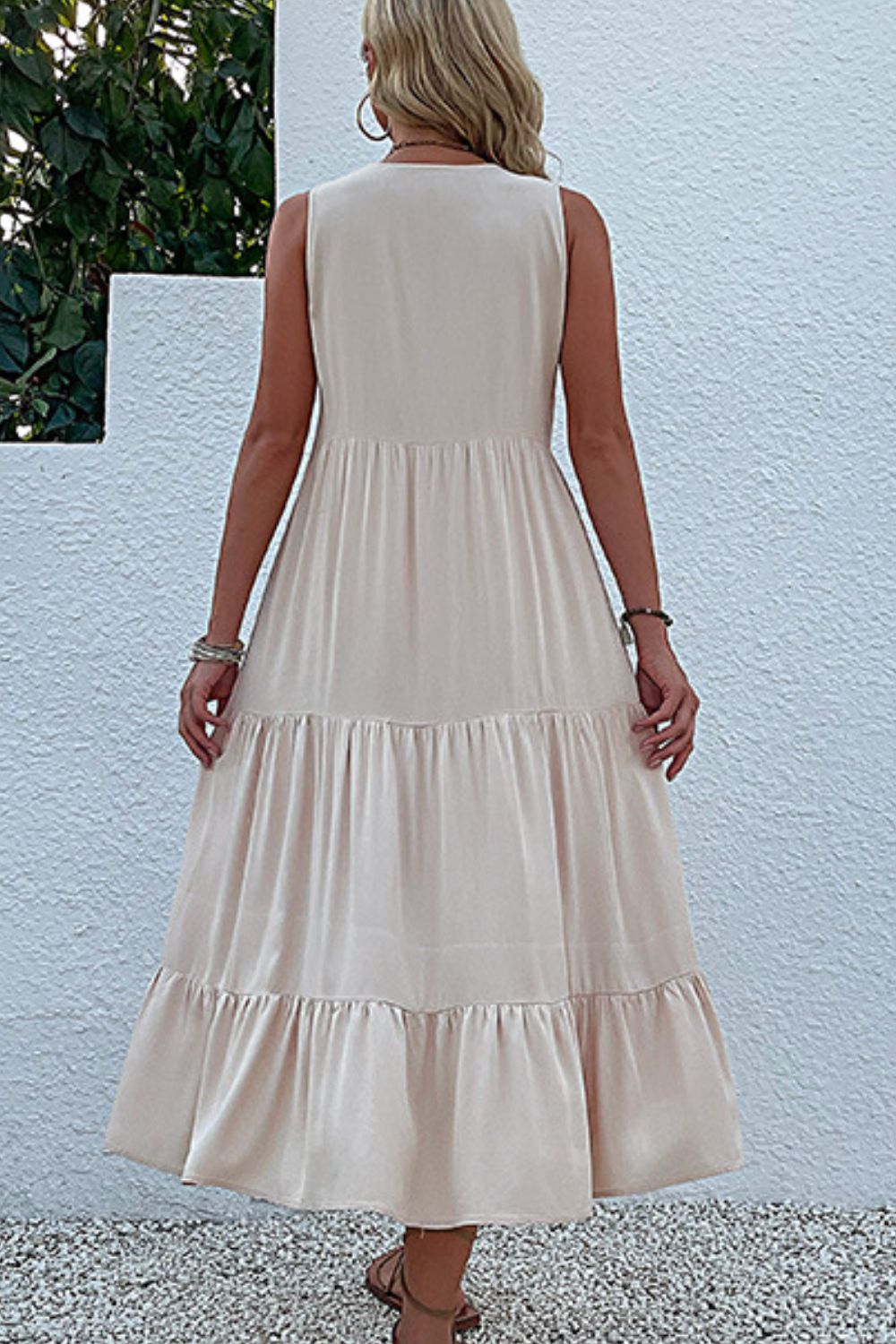 Ivory sleeveless tiered maxi dress, back view with tiered hem