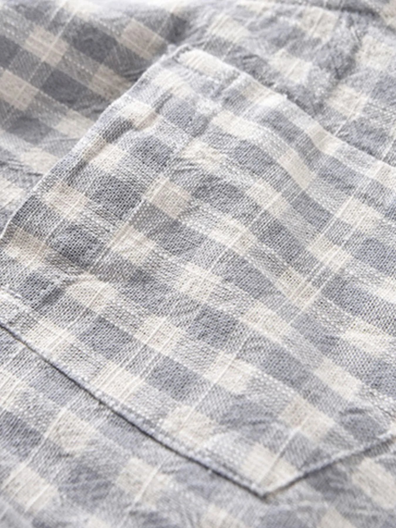 Gray plaid button-up shirt with curved hem and textured fabric weave