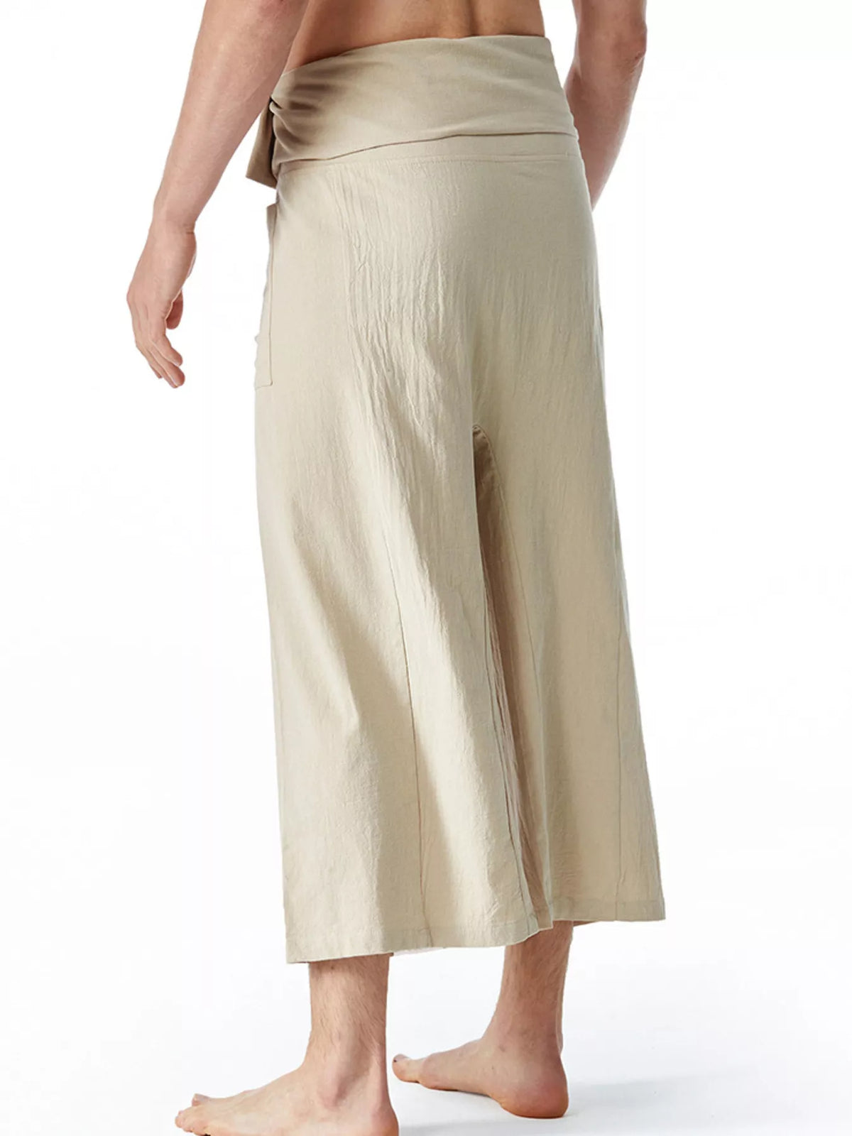 Men's loose-fit drawstring pants in cream, back/side view with relaxed wide leg.