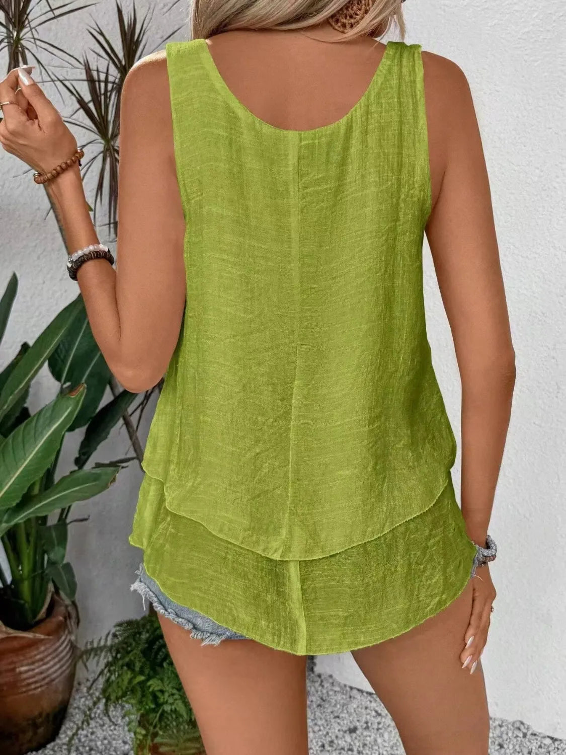 Matcha green wide-strap layered tank from the back with open neckline cut and tiered hem.