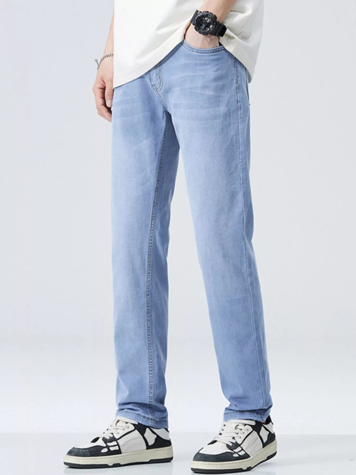 Men’s washed stretch straight-fit jeans, light blue, side view with belt loops and seams
