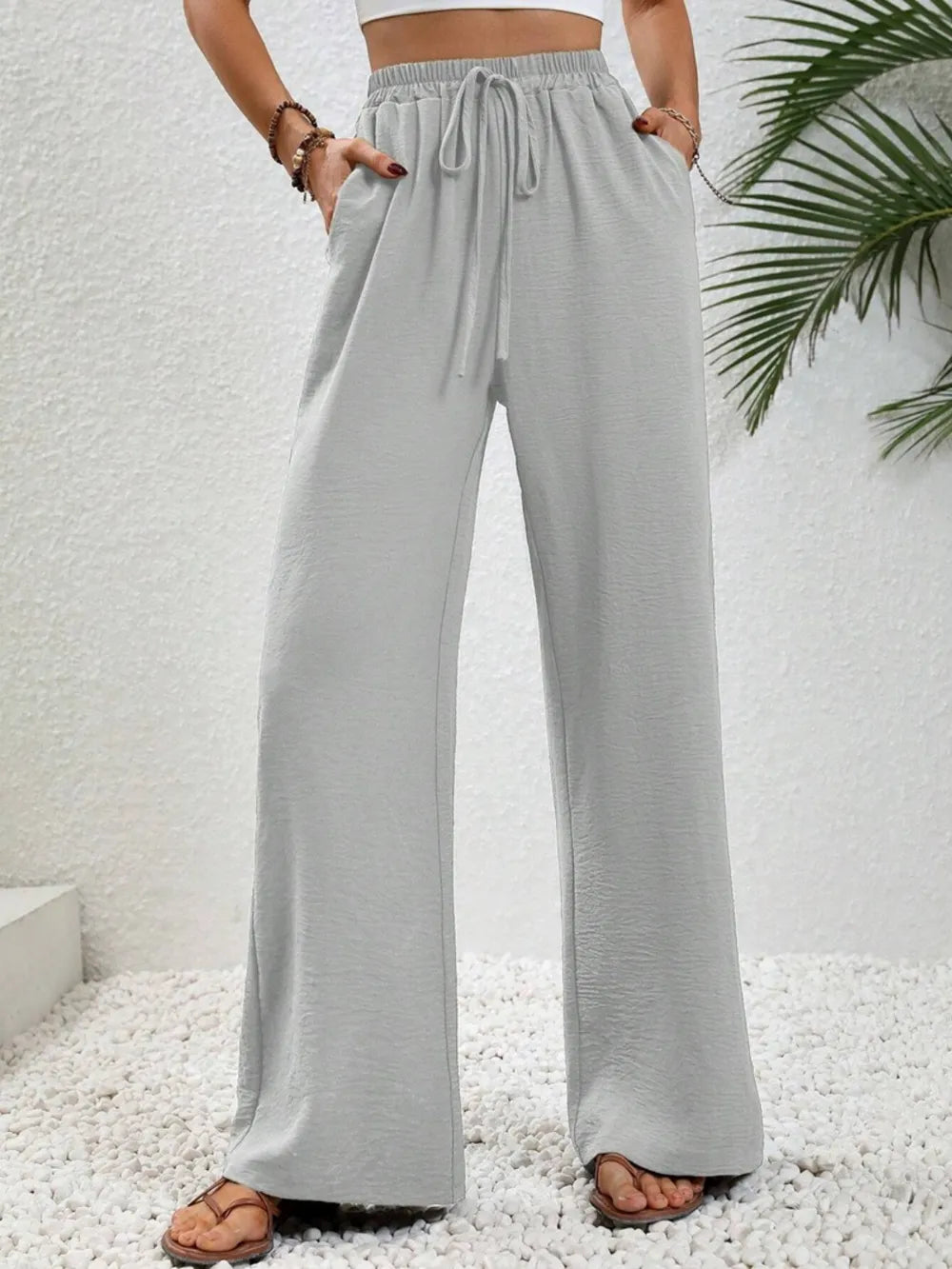 Light gray wide-leg drawstring pants with elastic waistband and tie front