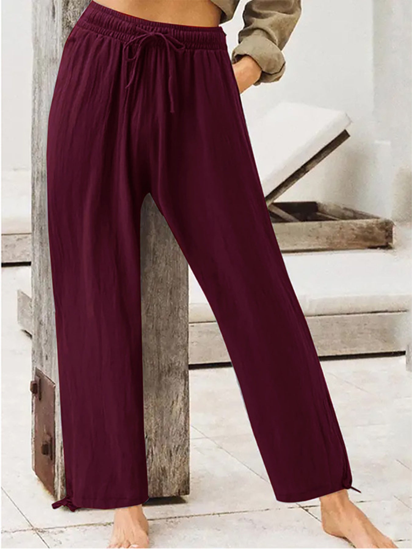 Burgundy wide-leg drawstring pants with elastic waist and relaxed flowy legs