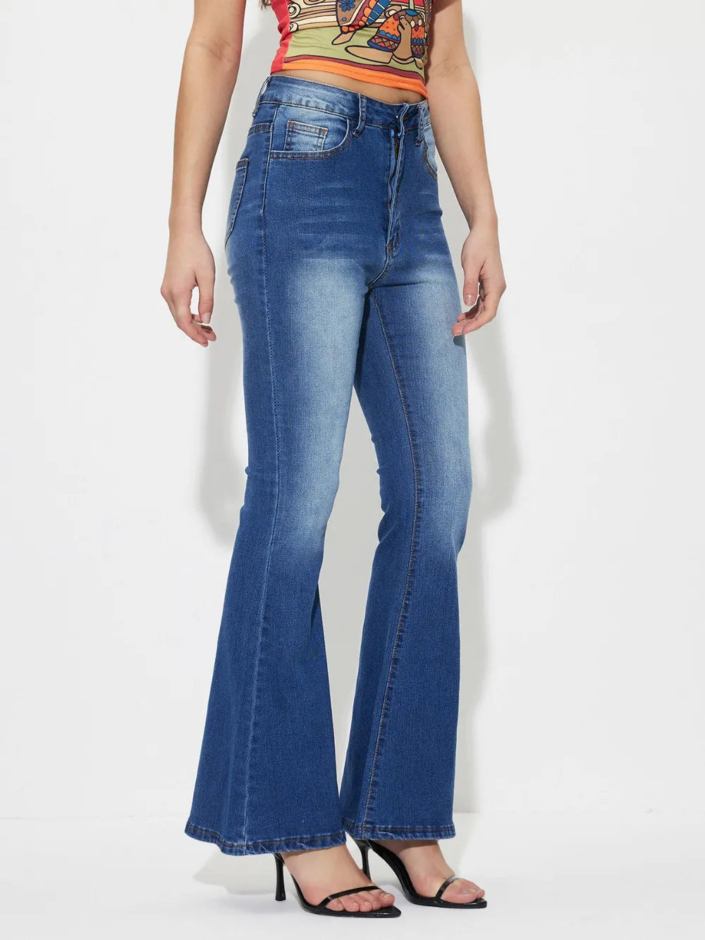 Mid-rise bootcut jeans, medium blue wash, back pockets and flared hem