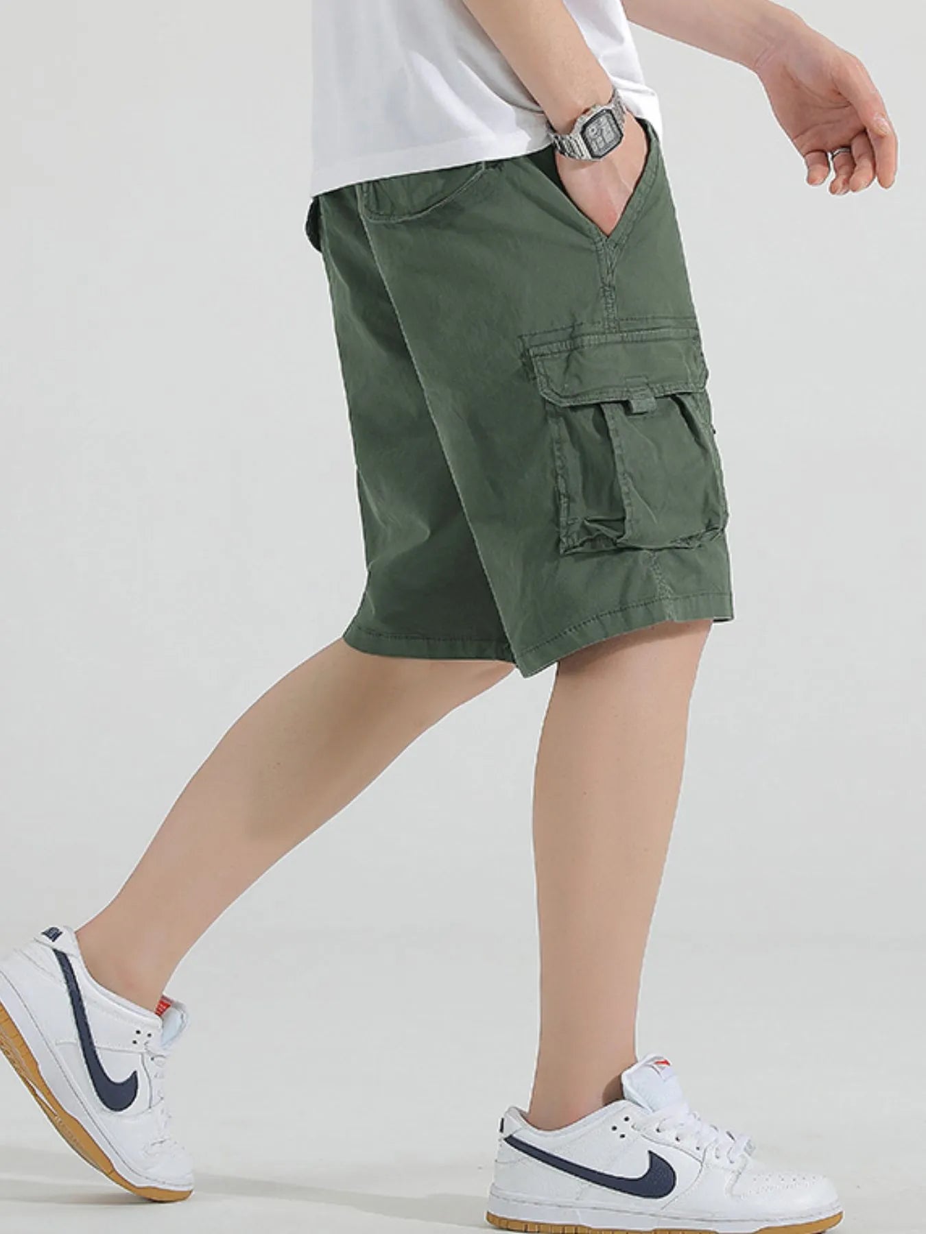 Green drawstring cargo shorts with thigh cargo flap pocket and relaxed fit