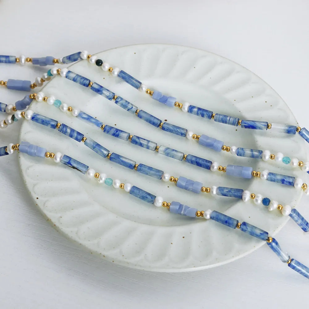 Freshwater pearl and blue bead necklace with multiple strands and gold spacer beads