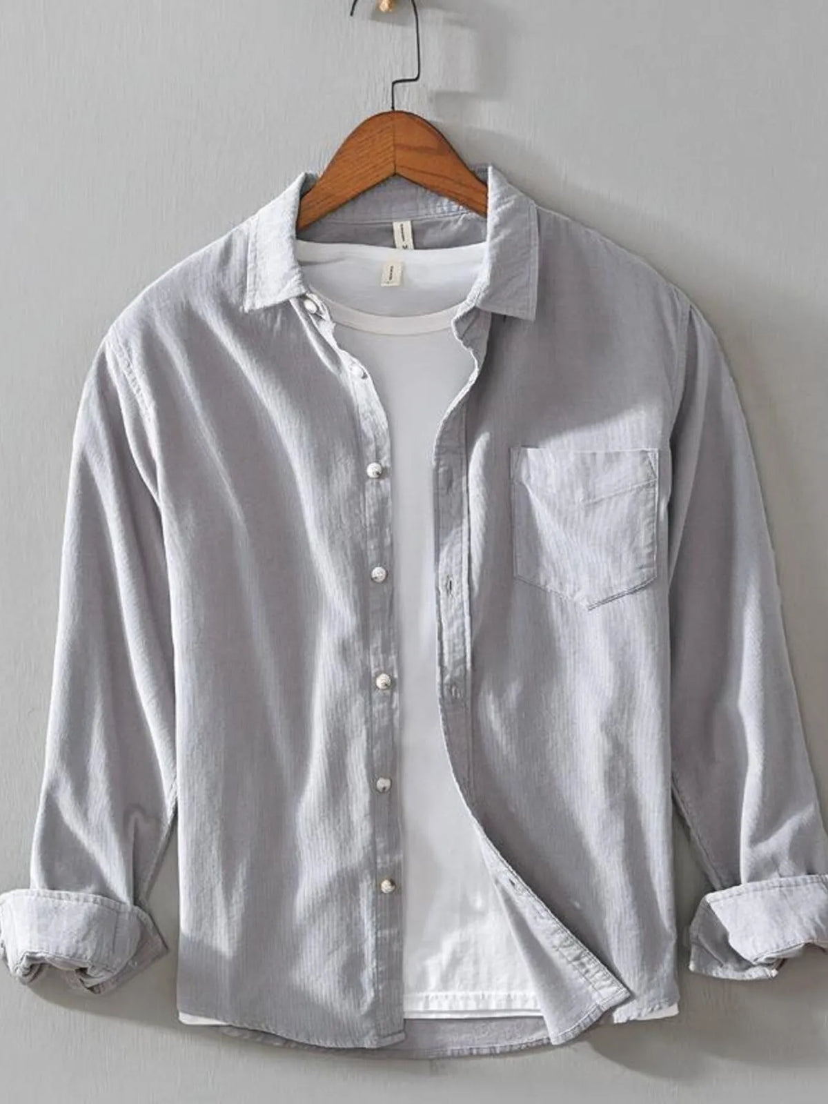 Men's light gray cotton button-up shirt with long sleeves, buttons, and chest pocket