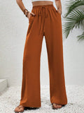 Caramel wide-leg drawstring pants with elastic waist and side pockets