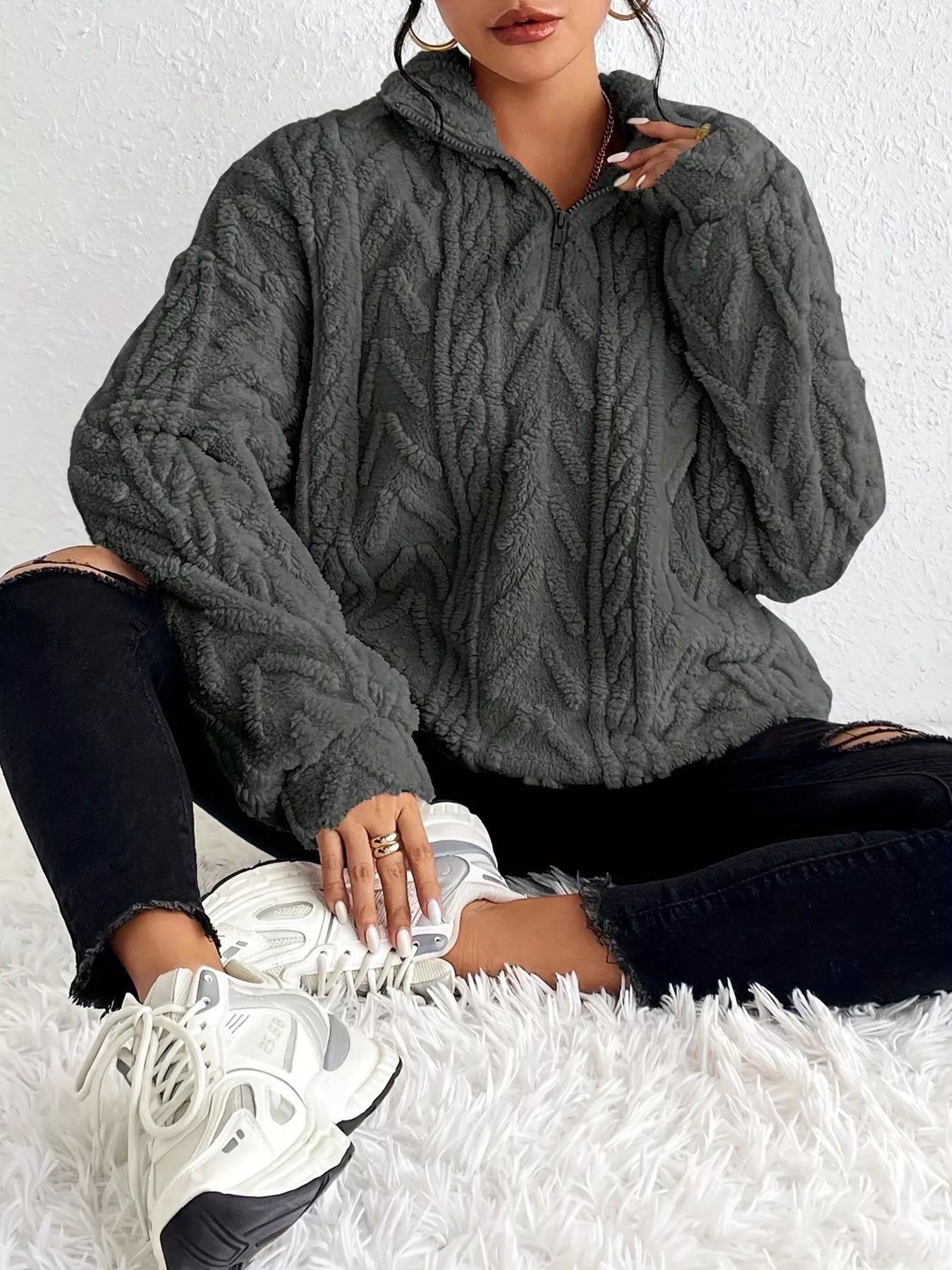 Dark gray sherpa quarter-zip sweatshirt with cable-knit texture and dropped shoulders