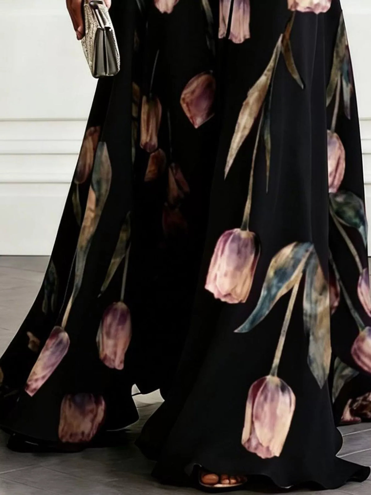 Black sleeveless floral print maxi dress with V-neck, ruched waist, and flowing skirt