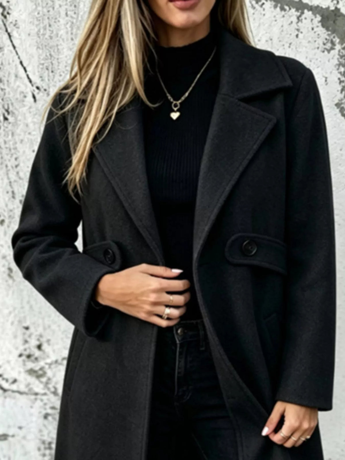 Black longline button-lapel coat with two flap pockets and front buttons