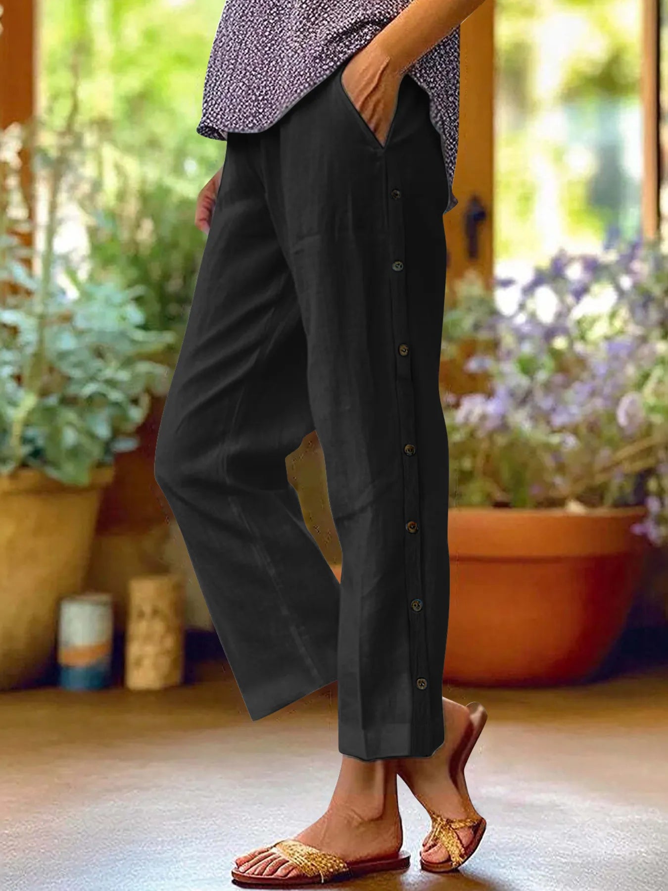 Black wide-leg pants with side button detail and elastic waist