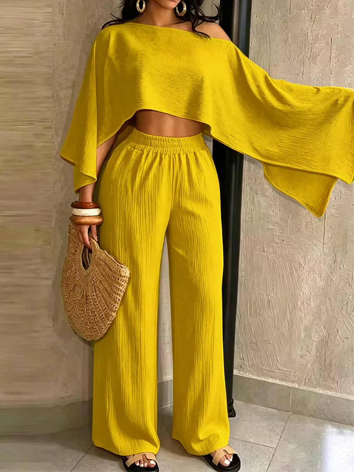 Yellow boat-neck crop top with elastic-waist wide-leg pants, draped sleeves.