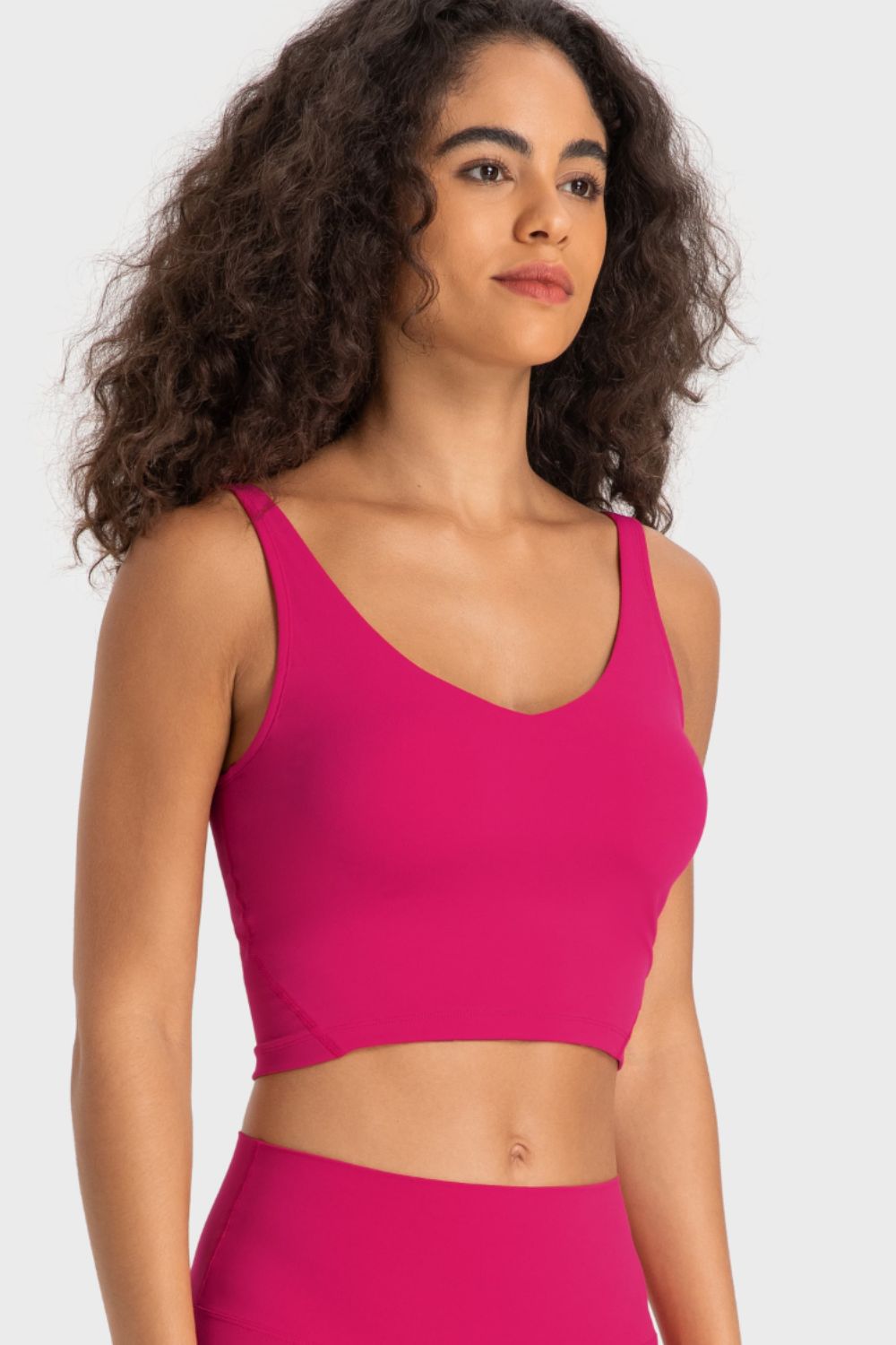 Hot pink deep V-neck crop sports bra, scoop neckline and racerback straps