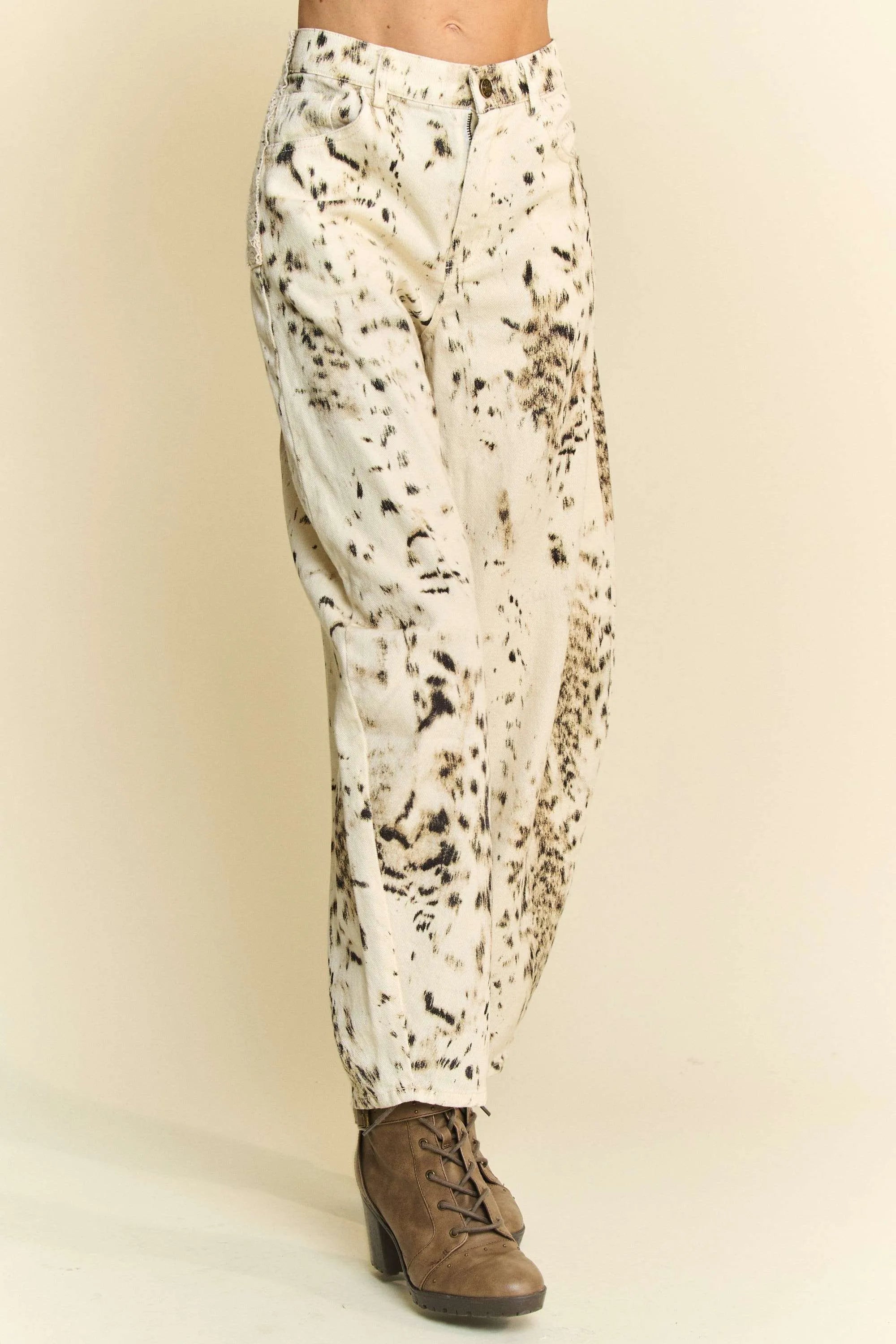 Cream barrel-leg pants featuring a black speckled tie-dye dot print
