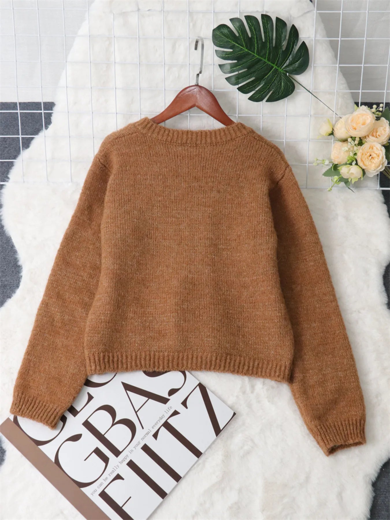 Brown ribbed hem cardigan sweater viewed from the back