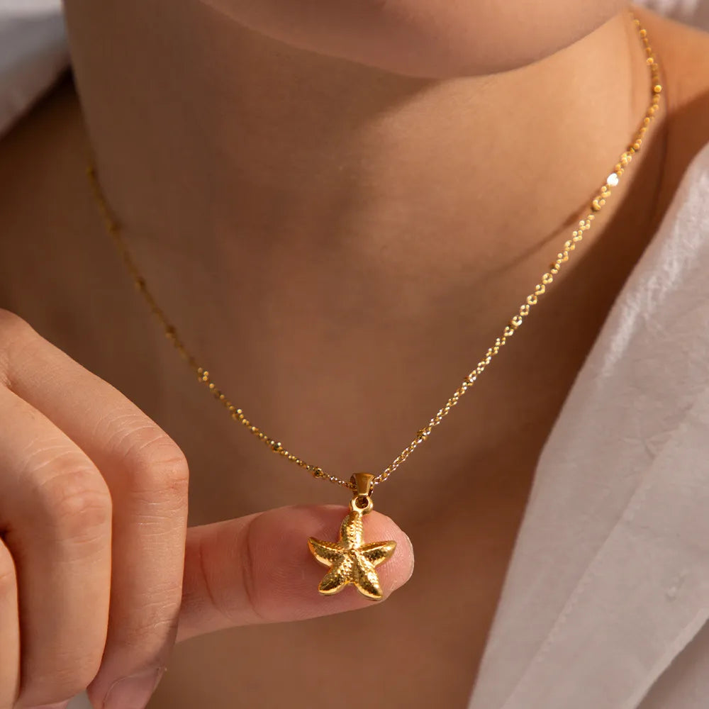 Gold-plated starfish pendant necklace with starfish charm centered on the chain