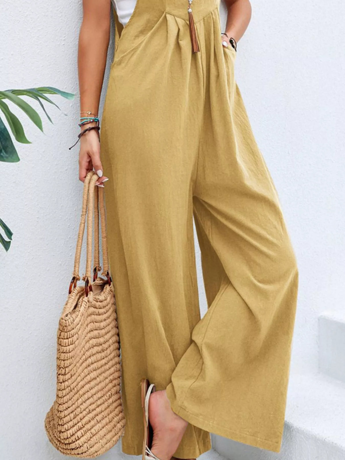 Light yellow wide-leg overalls with front pocket and wide, flowy pant legs