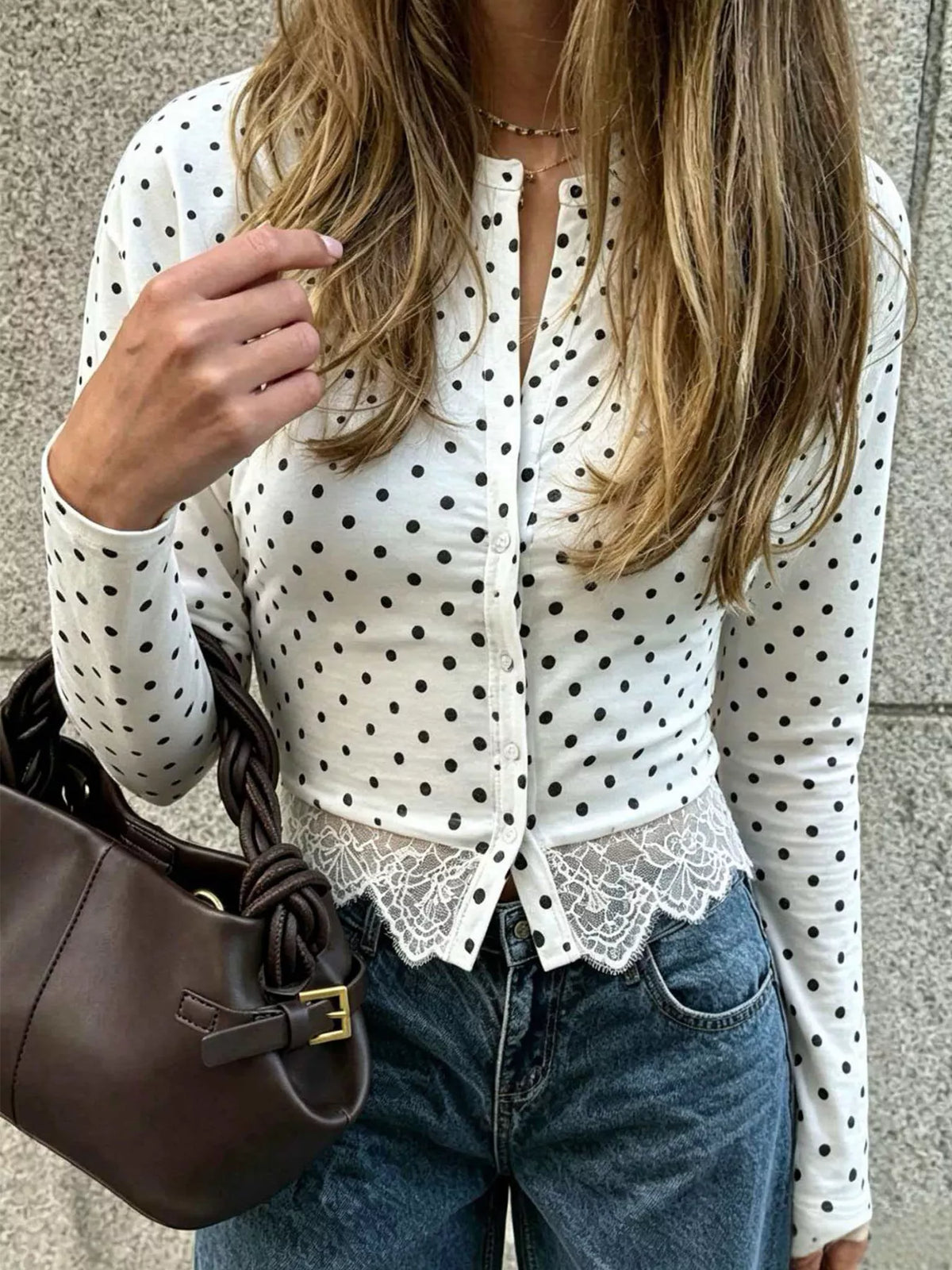 White polka dot long sleeve button-up lace-trim top, close-up front