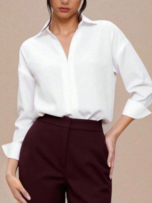 White button-down long-sleeve bodysuit with pointed collar and button placket