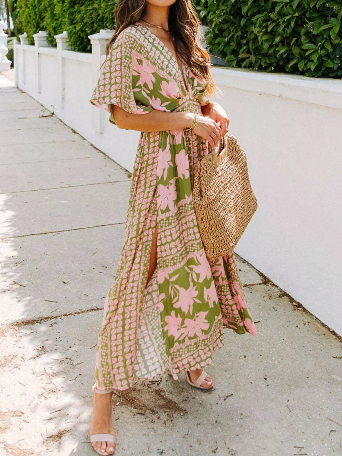 Pink floral maxi dress with V-neck, short flutter sleeves, and high slit in mint accents.