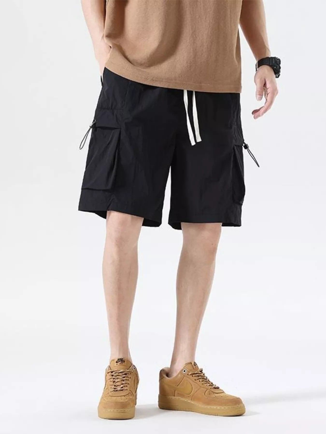 Black drawstring cargo shorts with side flap pockets and drawcord waist