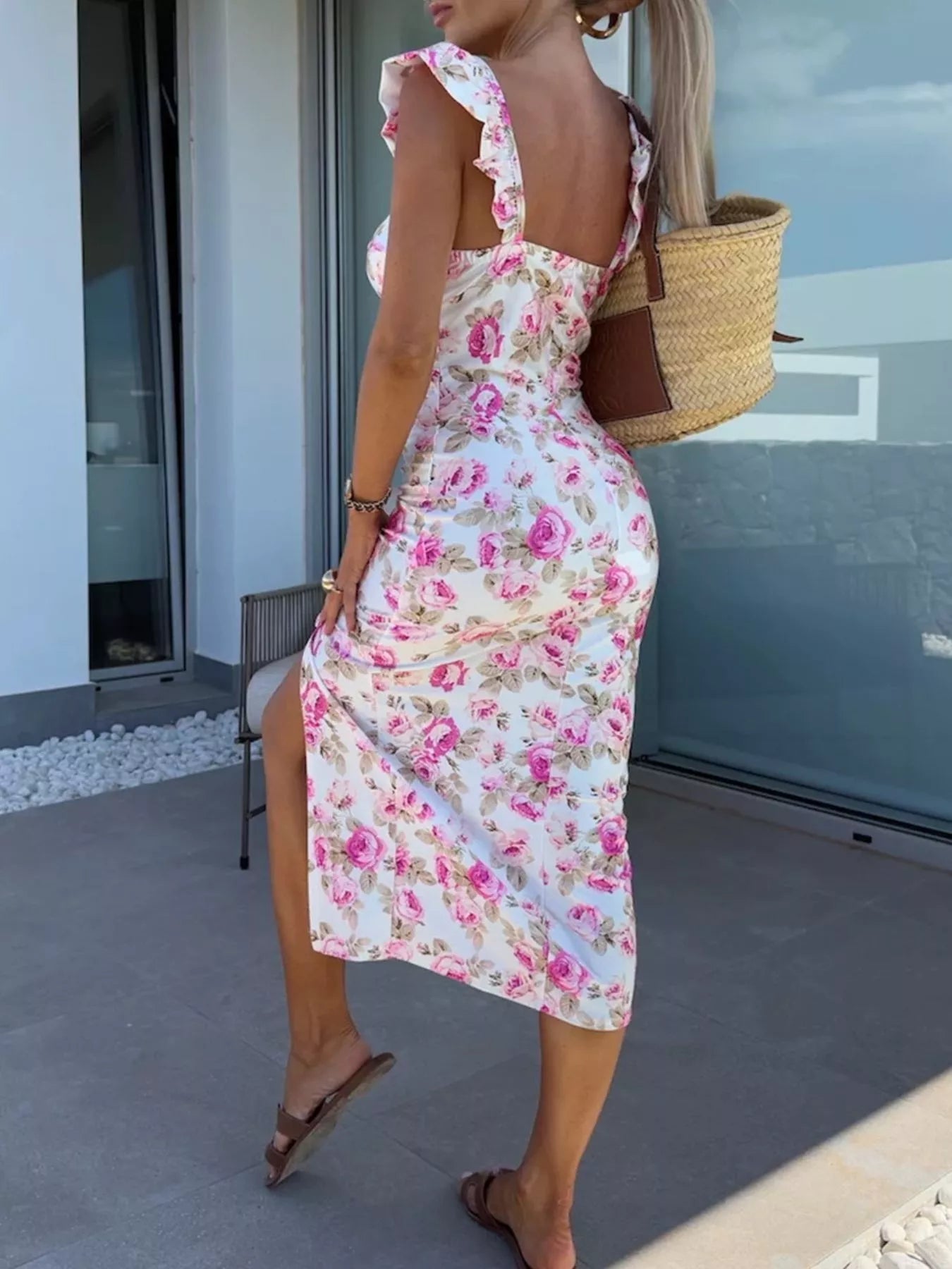 Pink floral midi dress with ruffle sleeves, fitted waist, and front slit