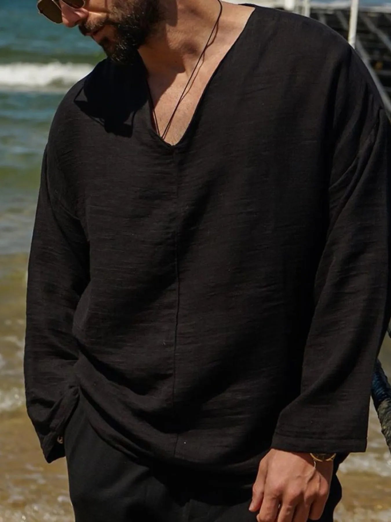 Black V-neck long sleeve men’s top with relaxed fit and textured look