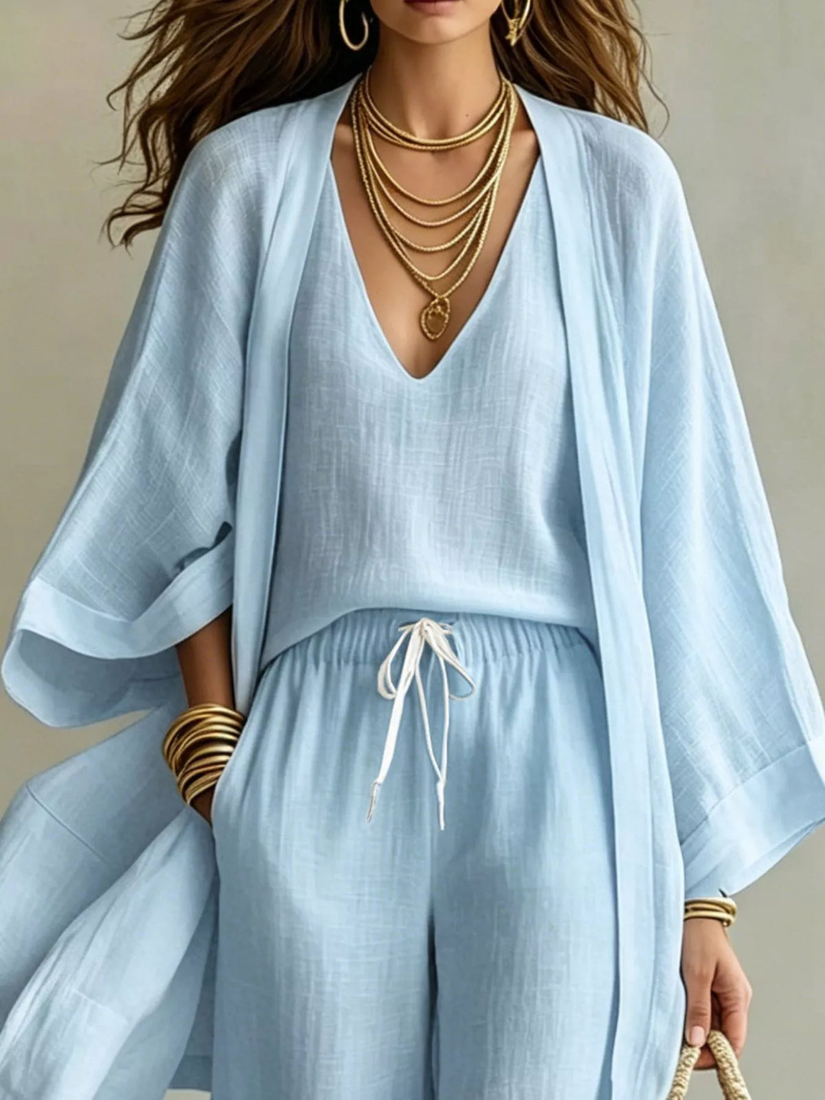 Sky blue V-neck top and drawstring pants with open cardigan, upper body view