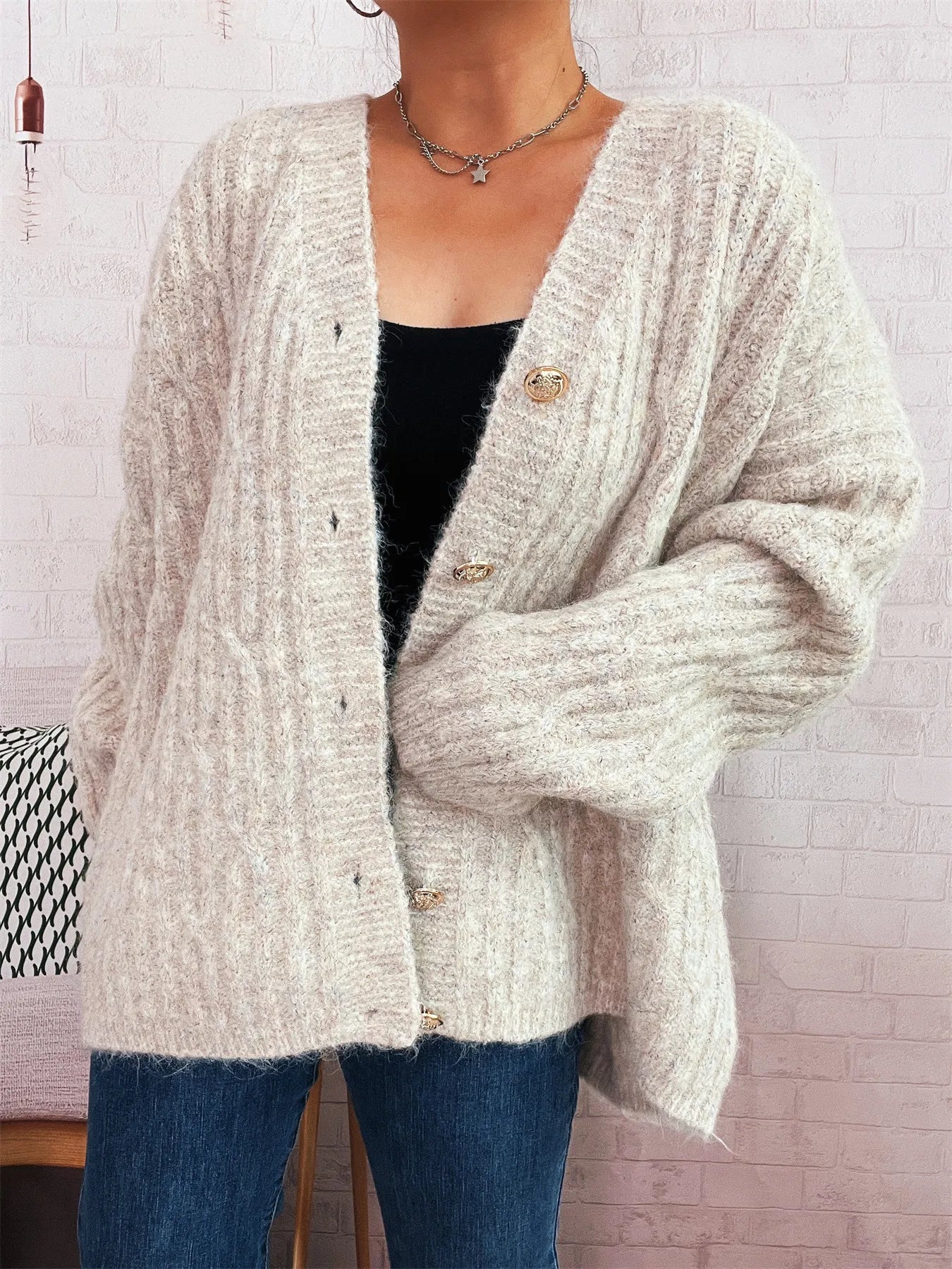 Cream cable knit button-up cardigan, V-neck front with gold-tone button placket