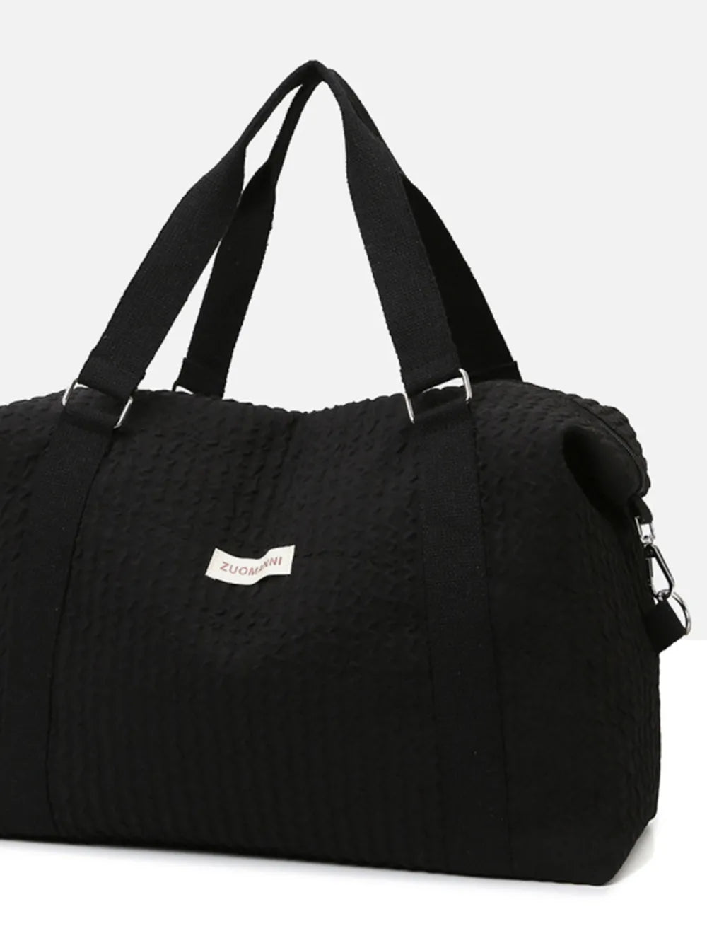Black textured large duffle travel bag with two top handles and metal zipper