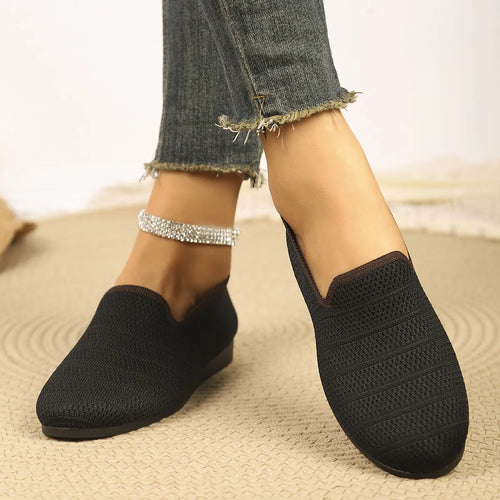 Black knit slip-on loafers with textured upper and low profile soles