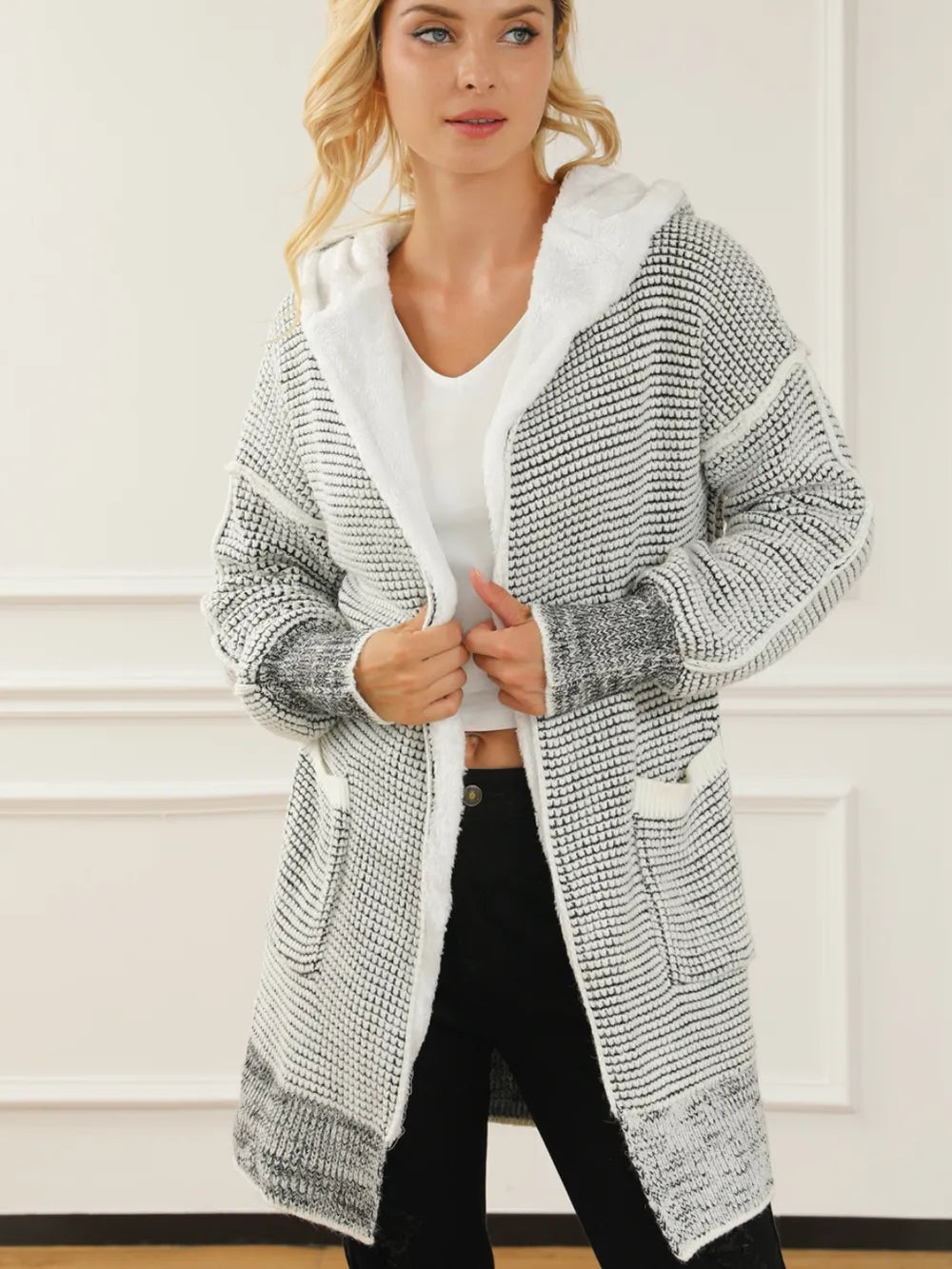 Open-front hooded winter coat with pockets, light gray-and-white textured knit with hood lining.
