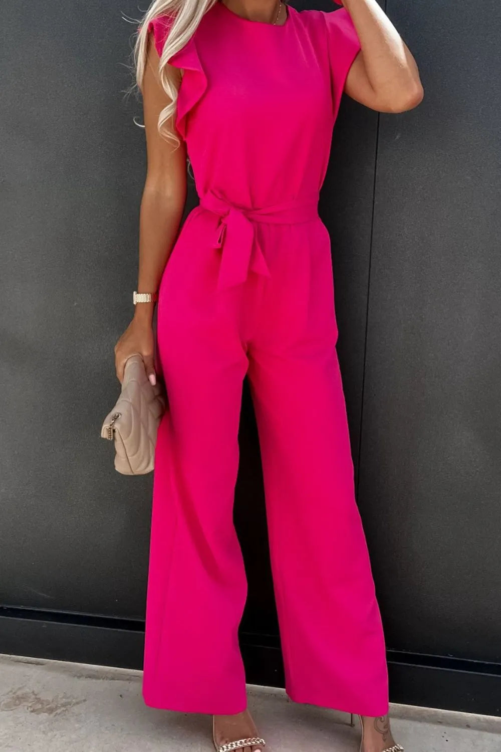 Pink round-neck cap sleeve jumpsuit with tied waist and wide straight legs