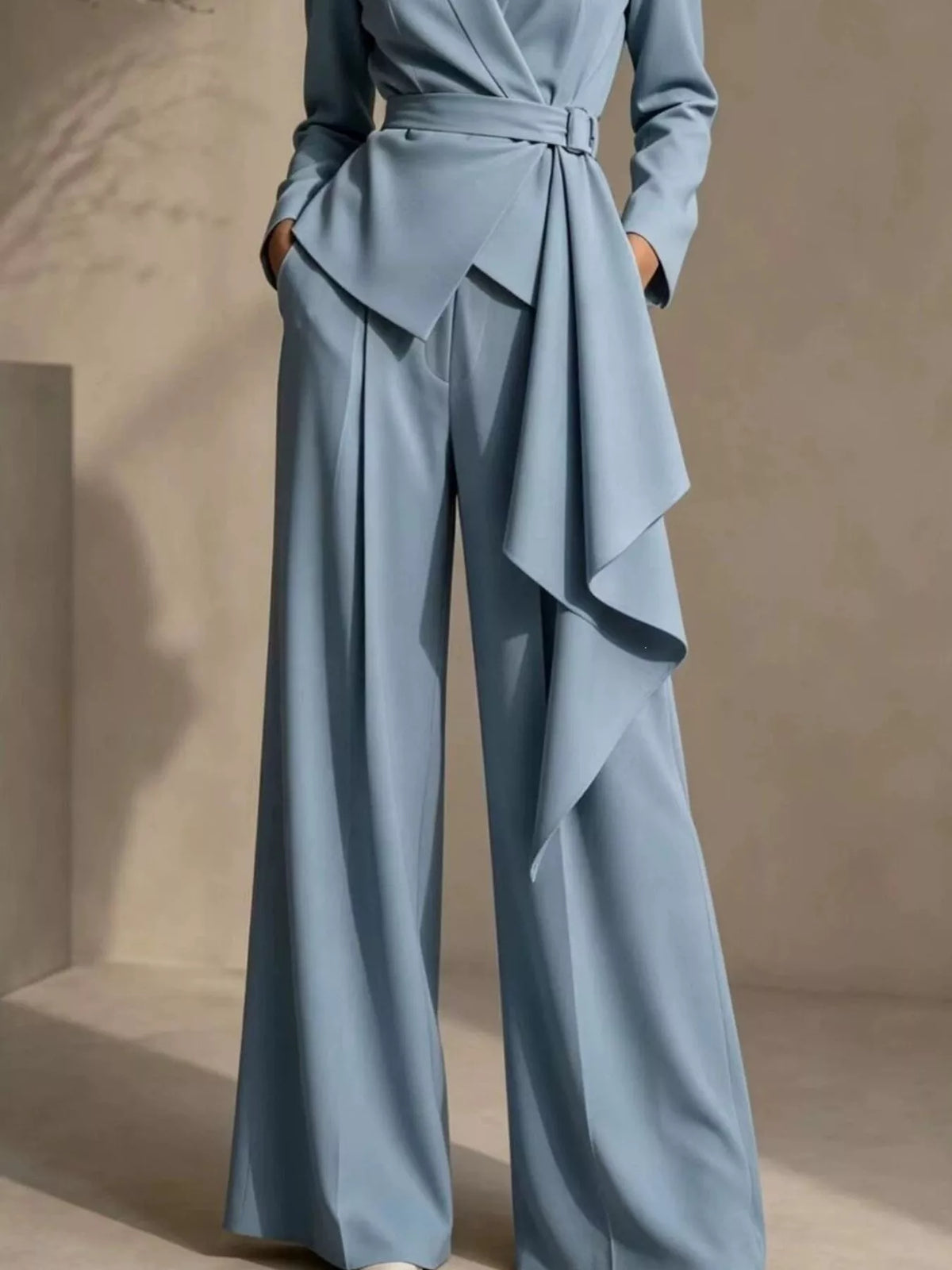 Light blue belted blazer and wide-leg pants with layered waist drape