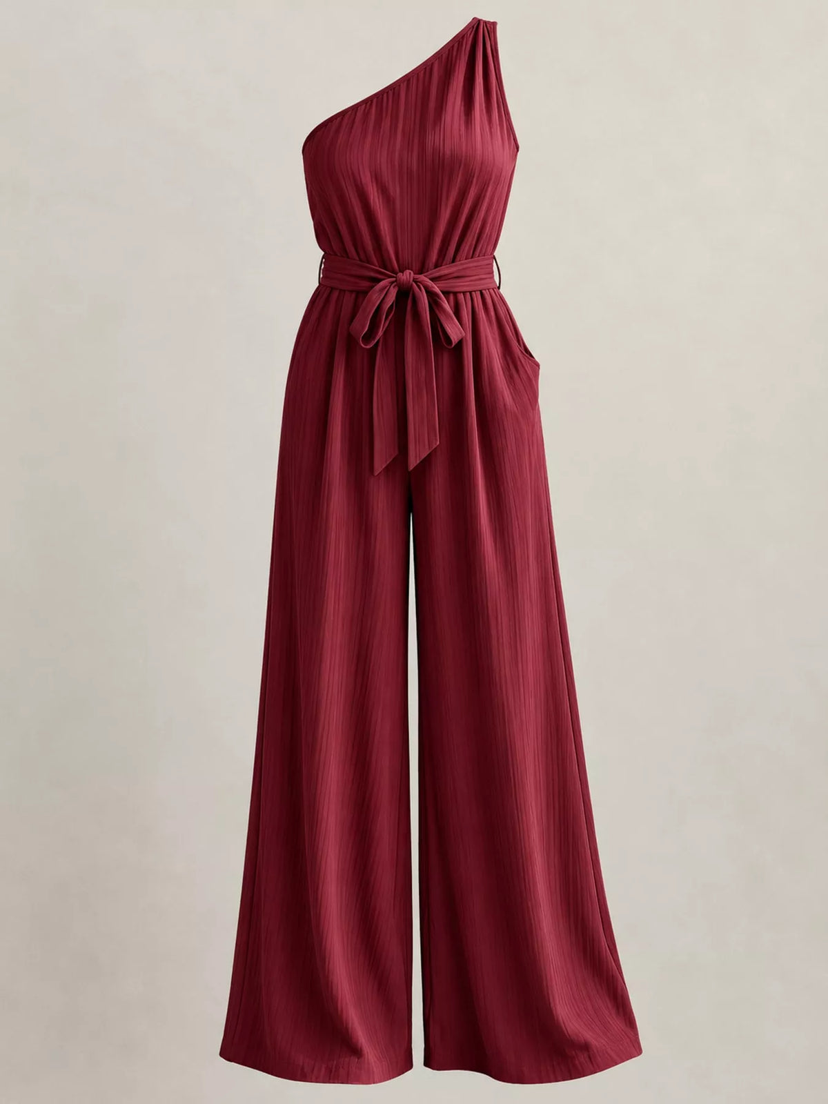 Burgundy one-shoulder pleated jumpsuit with ribbon bow waist tie