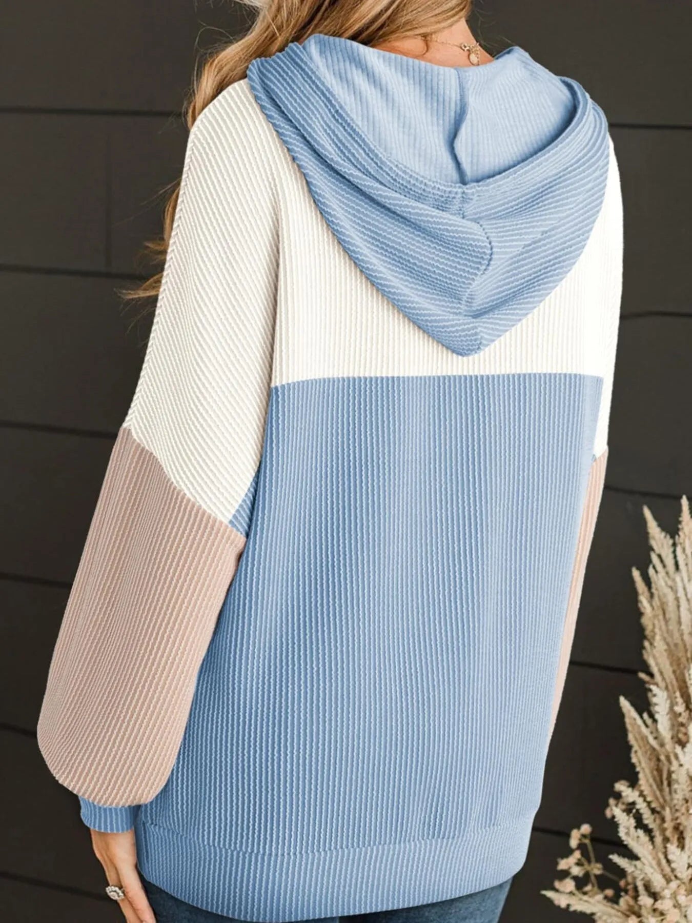 Color block long sleeve hoodie in light blue and cream, striped knit, drawstring hood, front pocket