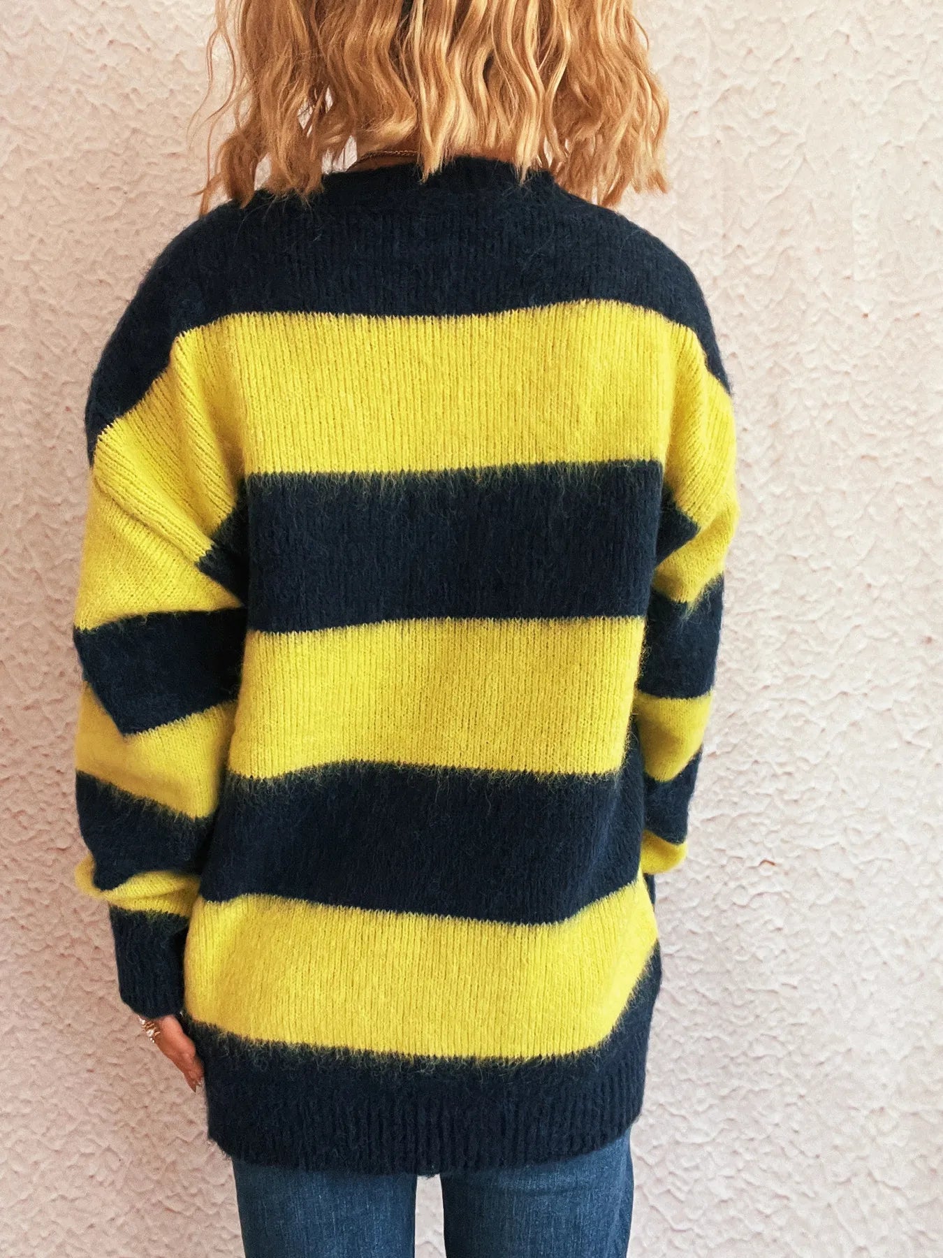 Back of yellow and navy striped long-sleeve sweater with crew neck and ribbed cuffs