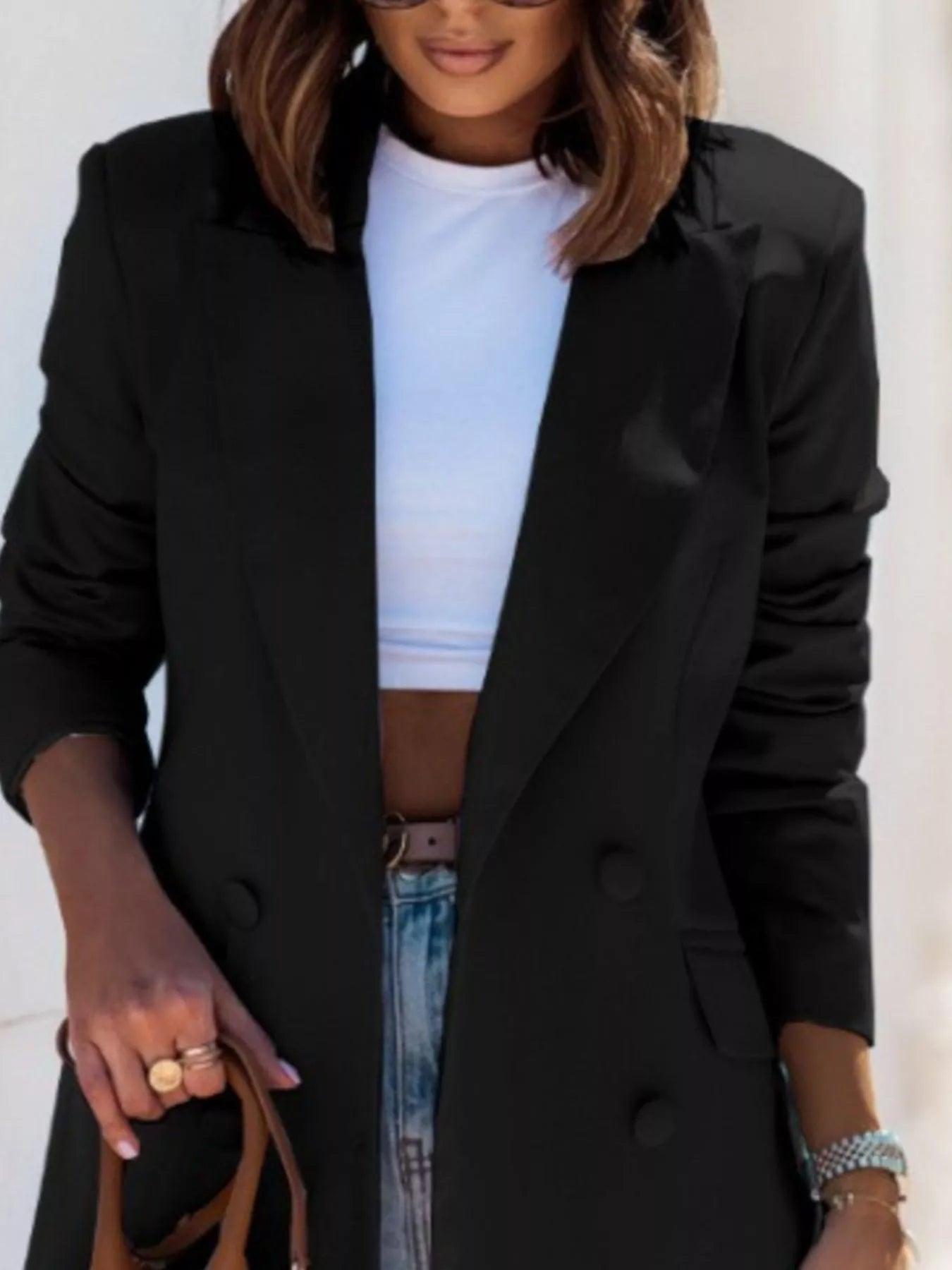 Black long-sleeve blazer with lapel collar, buttoned front, and flap pockets