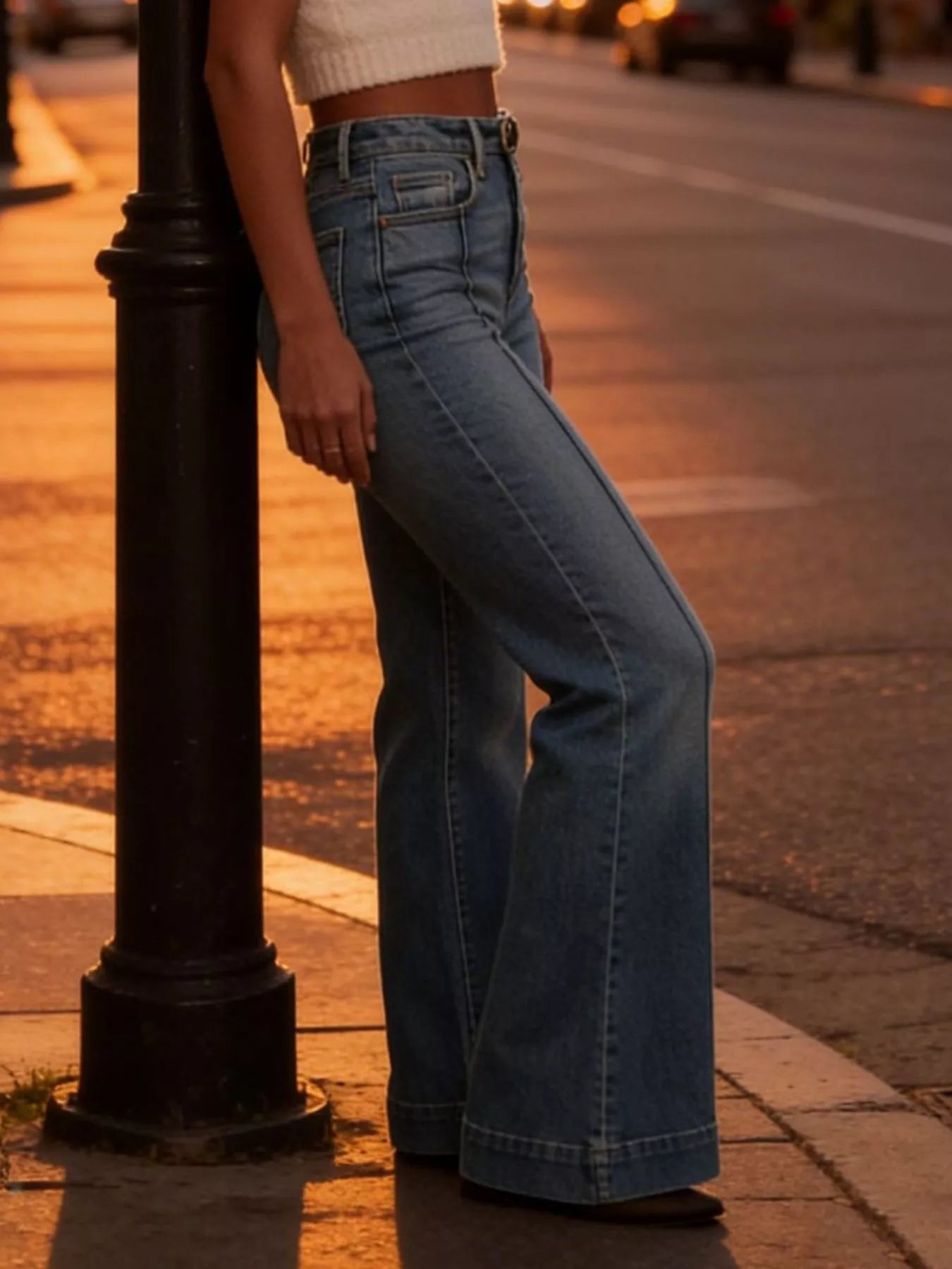 Blue high-waisted flare-leg jeans with side seams and wide flared hem