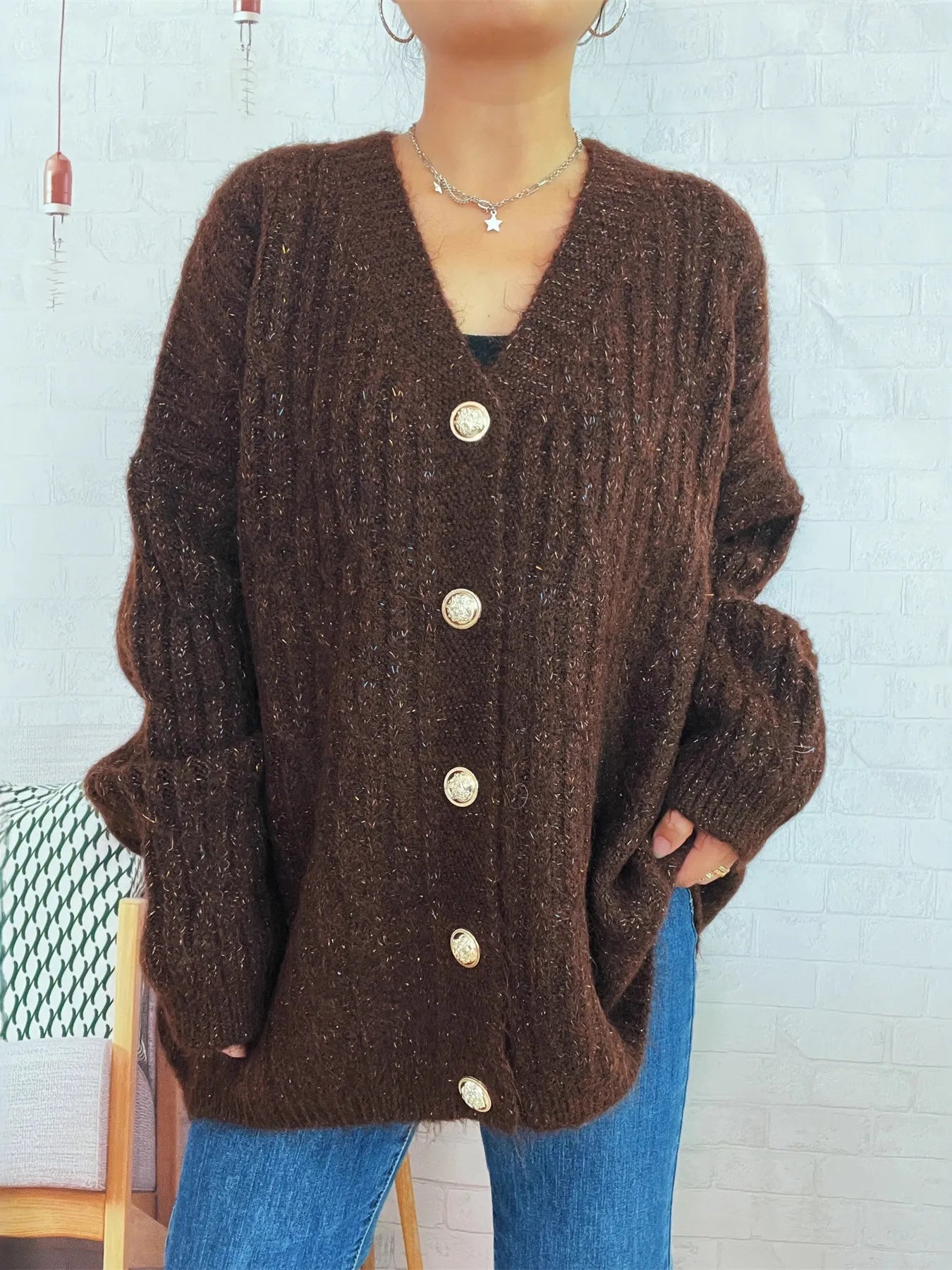 Brown cable-knit button-up cardigan with V-neck and five round buttons down center