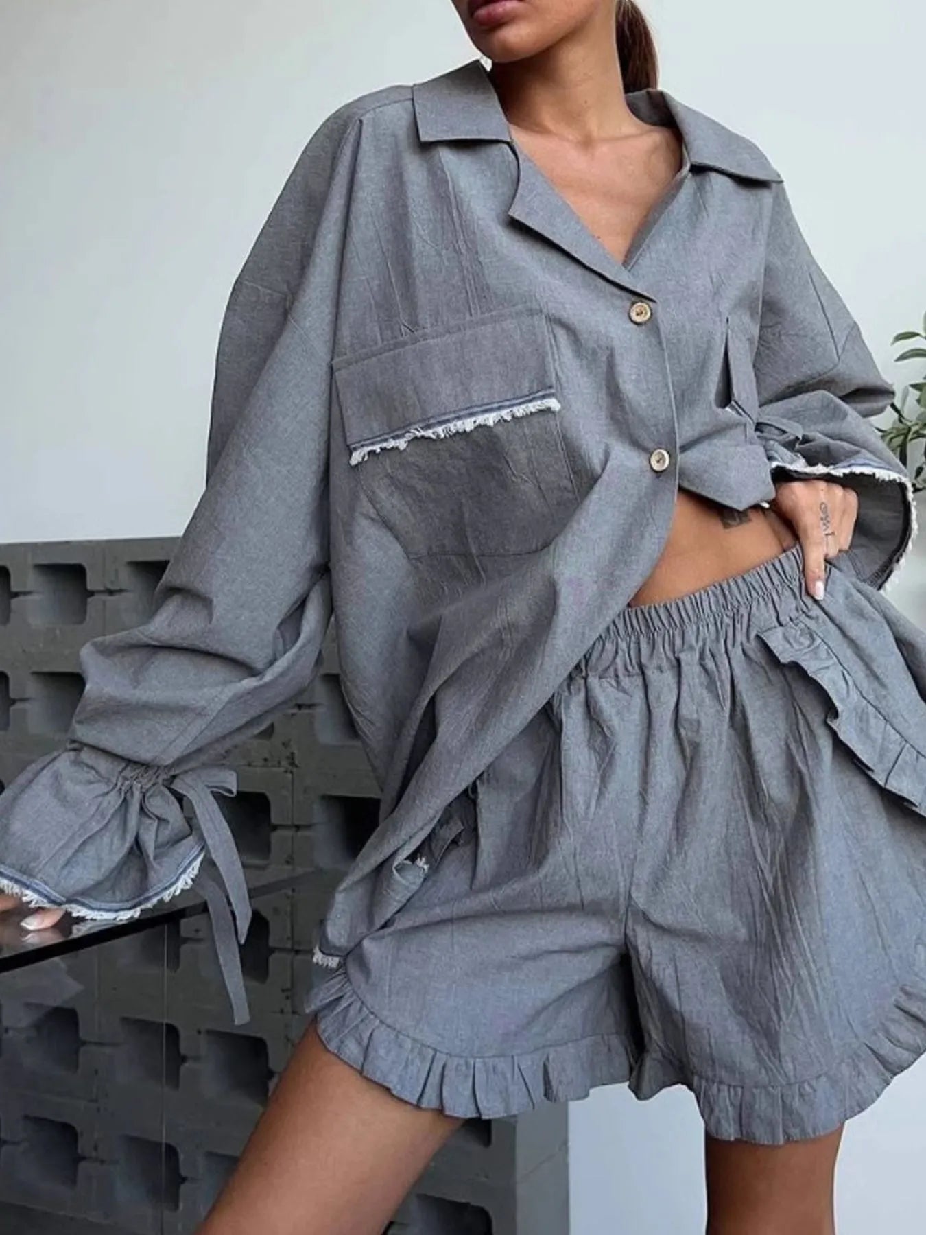 Dark gray button-up flounce-sleeve top with matching ruffle-hem shorts set