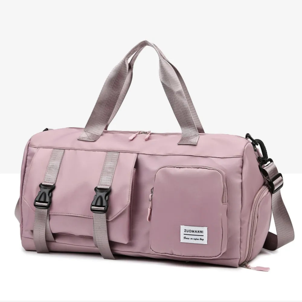 Large multi-pocket travel duffle bag in dusty pink with front organizer pockets and handles