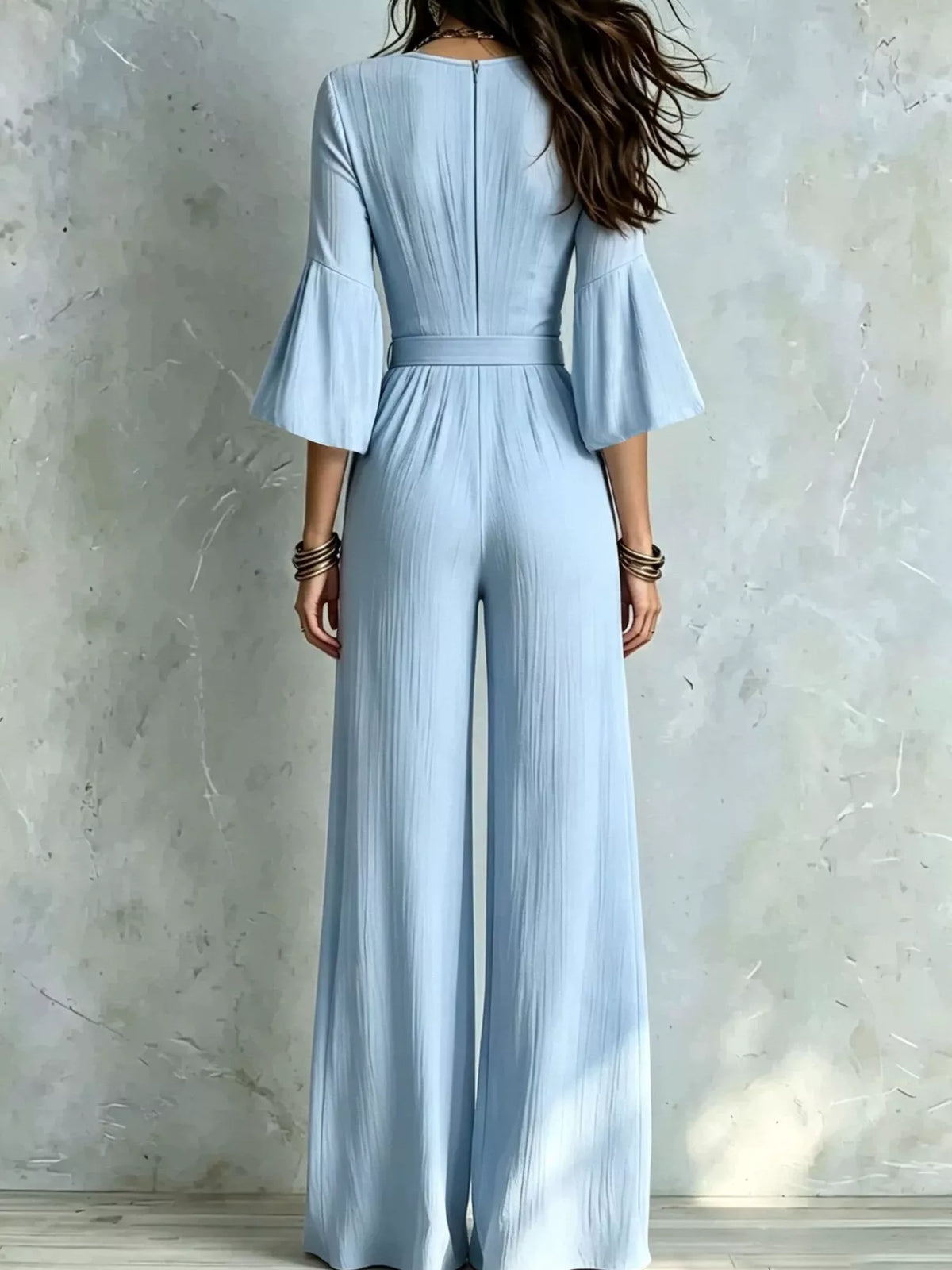 Sky blue wide-leg jumpsuit with pleated back waist and flared elbow sleeves