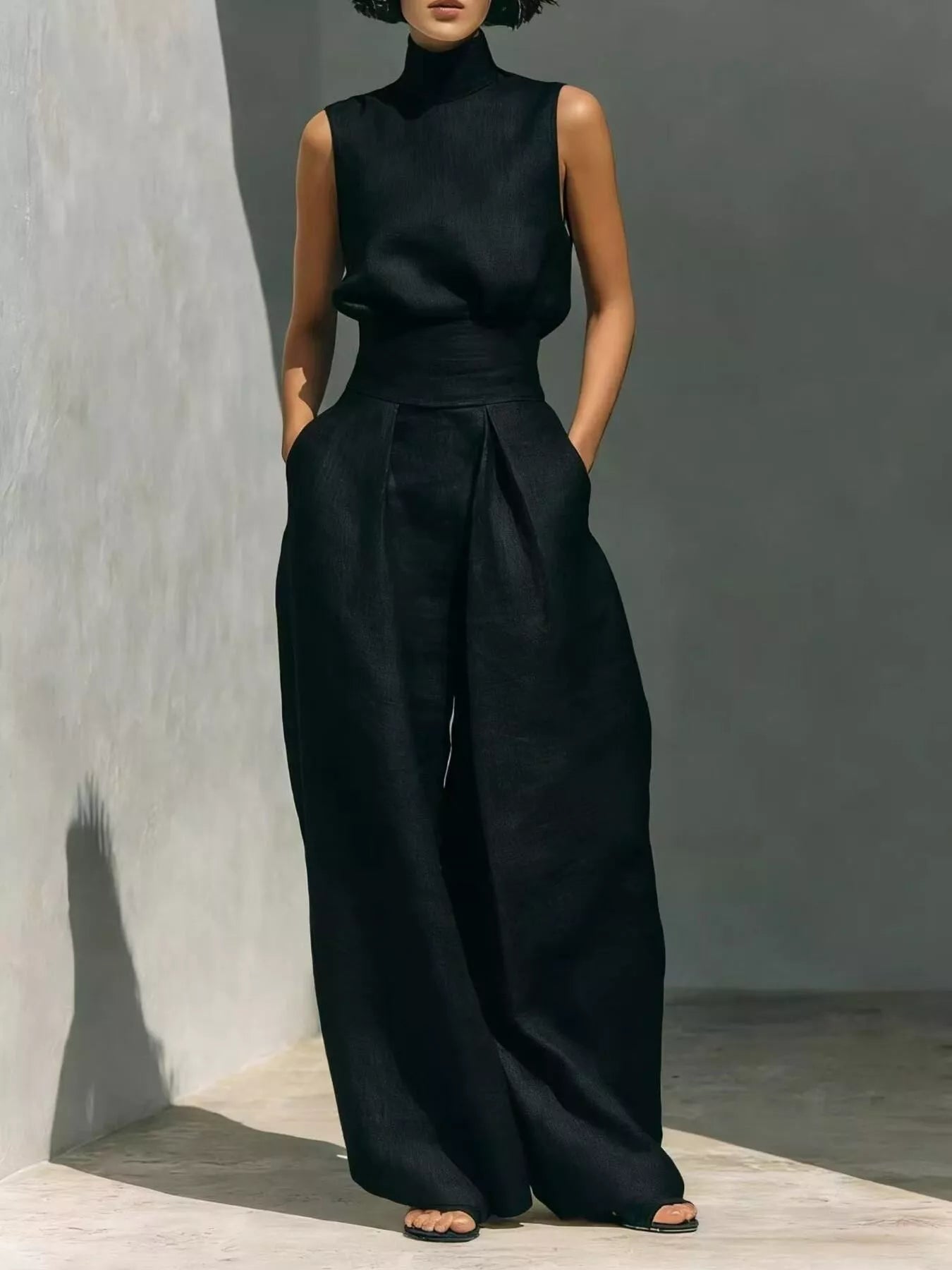 Black sleeveless turtleneck top with front waist knot and wide-leg pants set